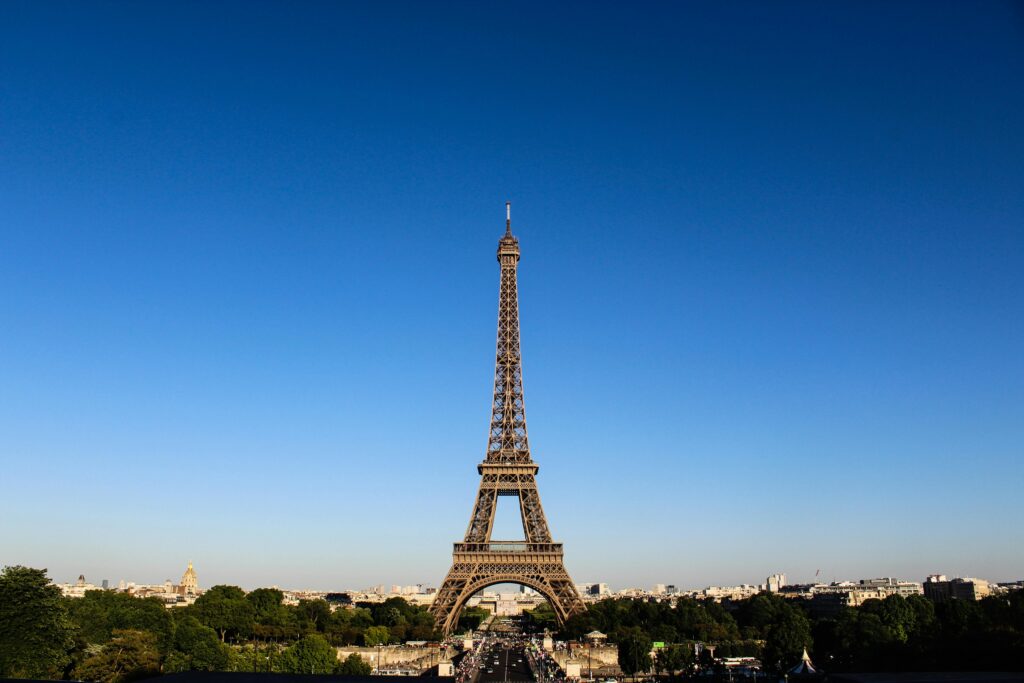 Attractions in France Stunning daylight shot capturing the Eiffel Tower with clear blue skies in Paris.